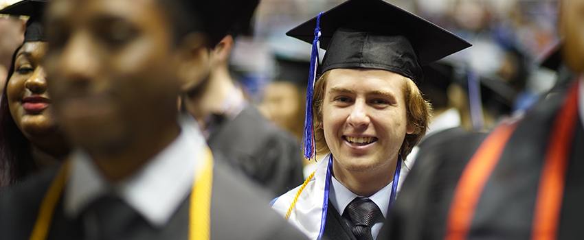 Male graduate smiling in ceremony
